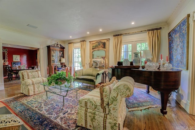 sitting room featuring light hardwood / wood-style floors, a healthy amount of sunlight, and ornamental molding