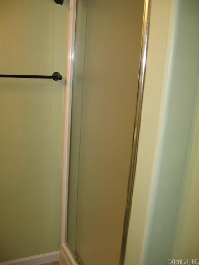 bathroom with a shower with shower door