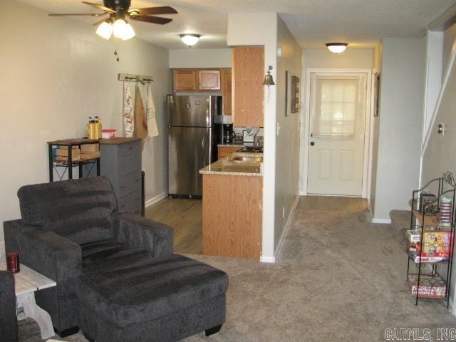 kitchen with ceiling fan, dark carpet, and stainless steel fridge