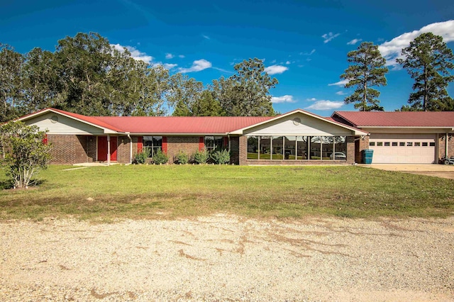 single story home featuring a garage and a front lawn