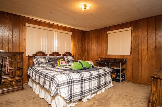 carpeted bedroom featuring wooden walls