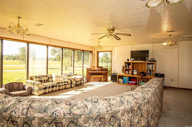 carpeted living room featuring ceiling fan and a textured ceiling