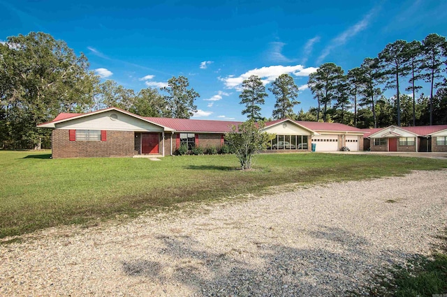 ranch-style home with a garage and a front yard