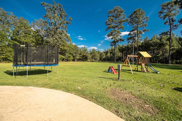 view of yard featuring a playground and a trampoline