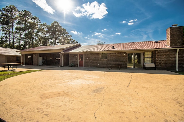 back of house with a patio