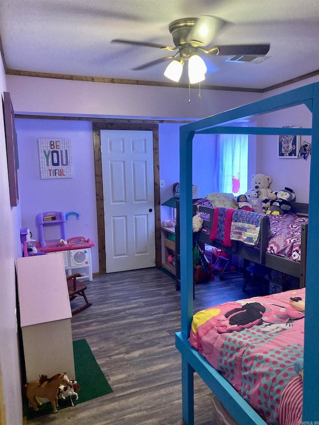 bedroom featuring hardwood / wood-style flooring, ceiling fan, a textured ceiling, and crown molding