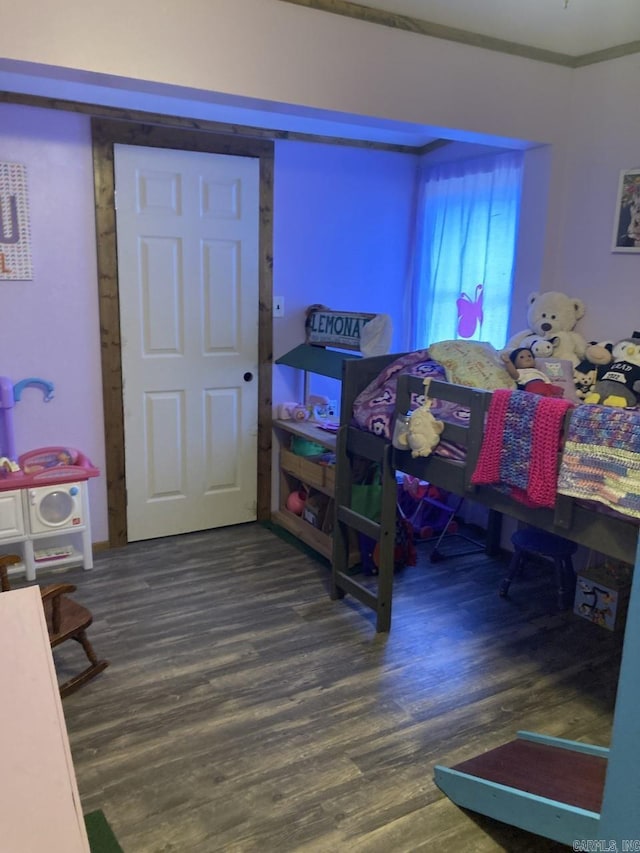 bedroom with wood-type flooring and ornamental molding