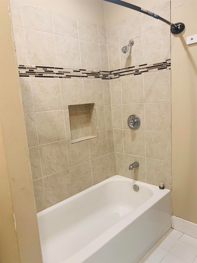 bathroom with tile patterned flooring and tiled shower / bath