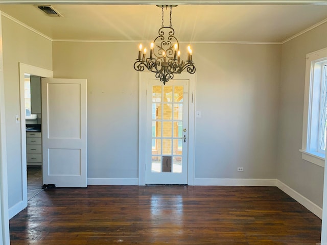 unfurnished dining area with crown molding, dark hardwood / wood-style flooring, and a notable chandelier