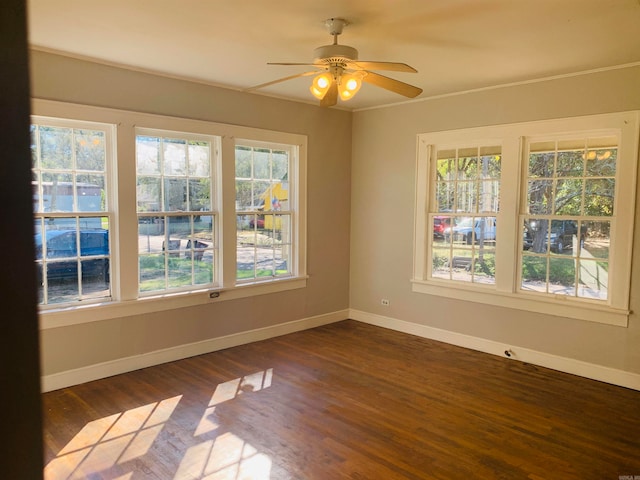 empty room featuring dark hardwood / wood-style flooring and ceiling fan