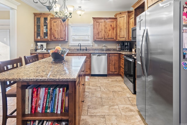 kitchen with stainless steel appliances, sink, ornamental molding, a kitchen island, and pendant lighting