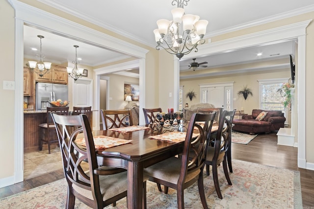 dining room with dark wood-type flooring and crown molding