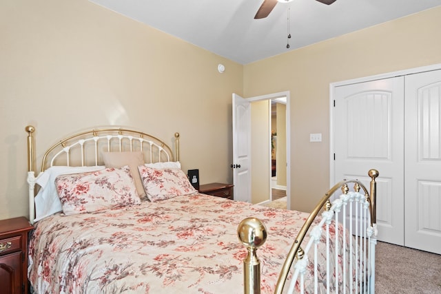 carpeted bedroom with ceiling fan and a closet