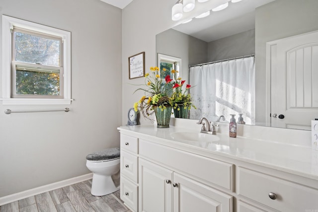 bathroom featuring hardwood / wood-style flooring, vanity, and toilet