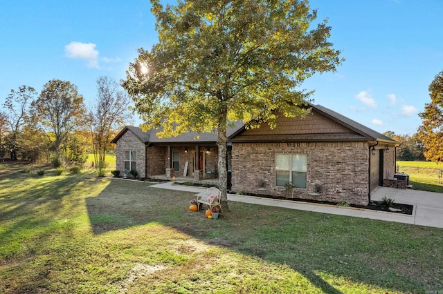 back of house with a patio and a lawn