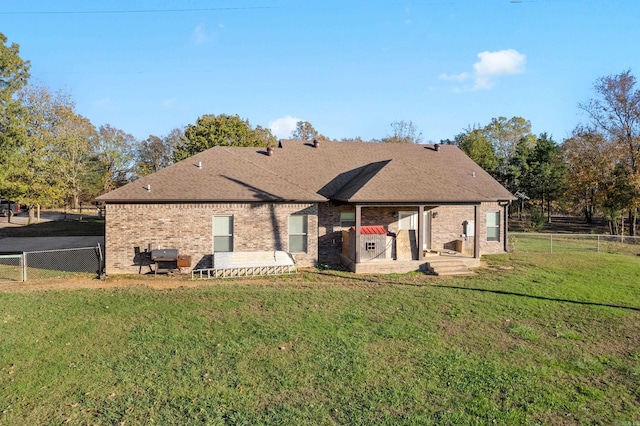 back of house with a patio and a yard