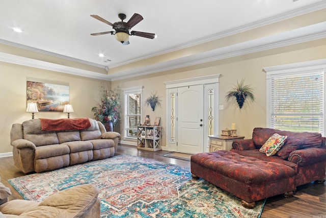 living room featuring dark hardwood / wood-style flooring, ceiling fan, a wealth of natural light, and ornamental molding