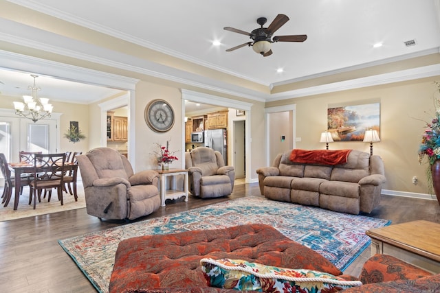 living room featuring ceiling fan with notable chandelier, ornamental molding, and dark hardwood / wood-style floors