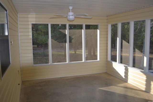 unfurnished sunroom with ceiling fan