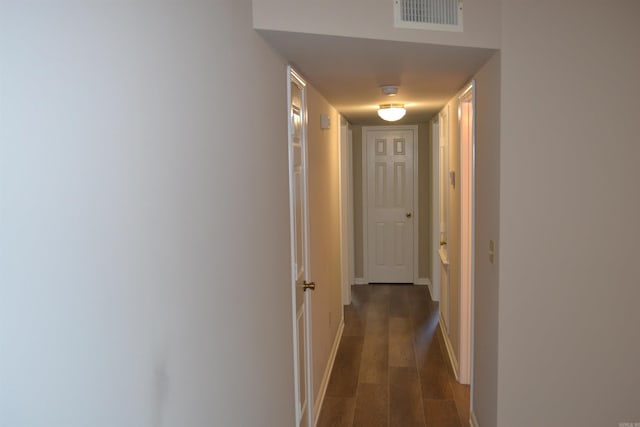 hallway with dark hardwood / wood-style floors