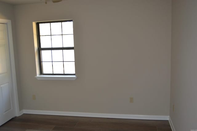 unfurnished room featuring dark hardwood / wood-style floors and plenty of natural light