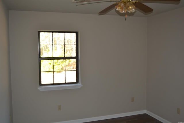 spare room featuring dark wood-type flooring and ceiling fan