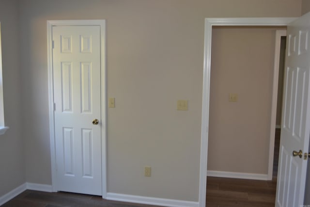 unfurnished bedroom with dark hardwood / wood-style floors