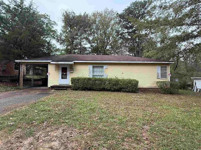 single story home with a front lawn and a carport