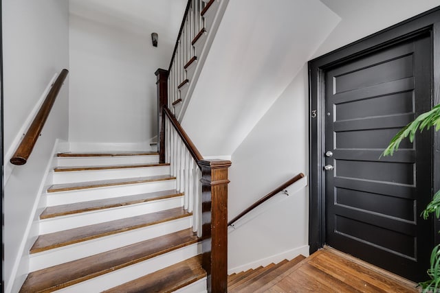 stairs with hardwood / wood-style floors