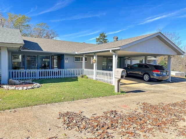 single story home with a front lawn and a carport