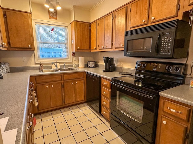 kitchen featuring black appliances, sink, and light tile patterned flooring