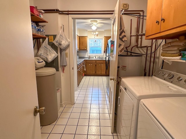 clothes washing area featuring cabinets, sink, ceiling fan, light tile patterned floors, and independent washer and dryer