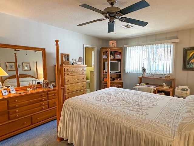 bedroom with a textured ceiling, dark carpet, and ceiling fan