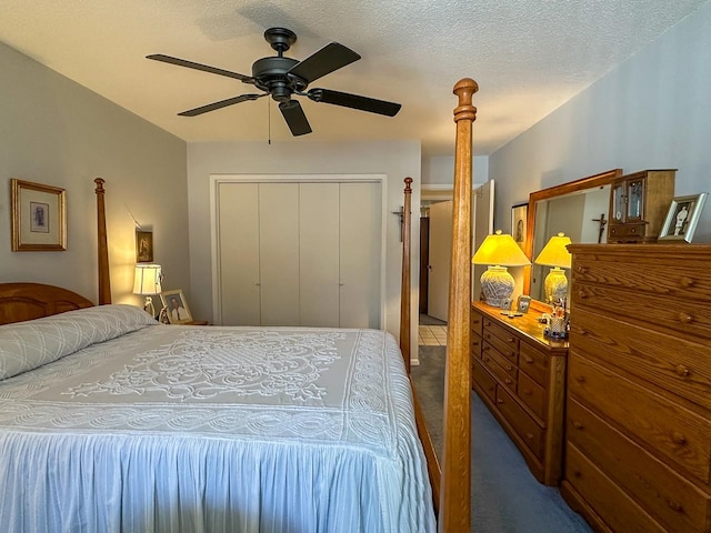 bedroom featuring a textured ceiling, a closet, ceiling fan, and dark carpet