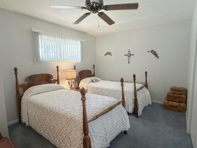 bedroom featuring a textured ceiling, dark carpet, and ceiling fan