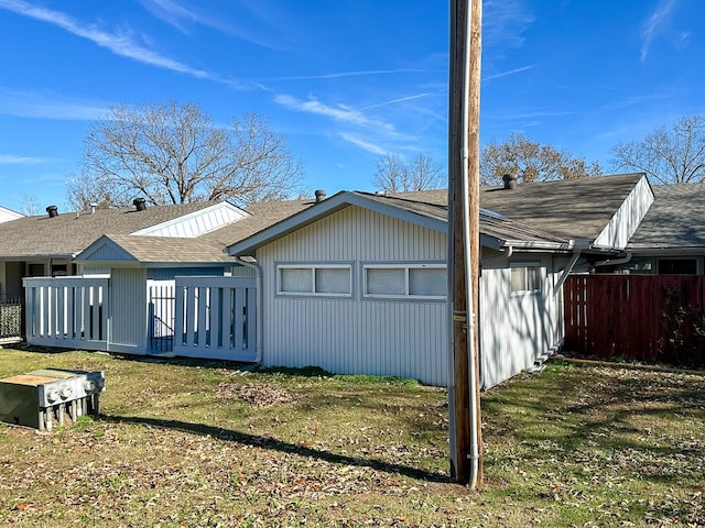 back of property featuring a yard