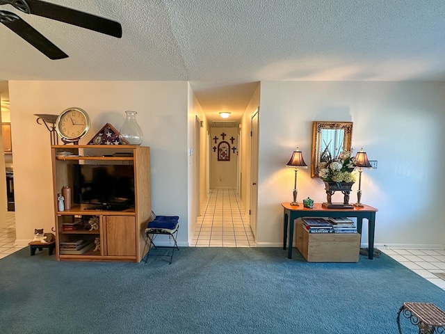 interior space featuring carpet flooring, a textured ceiling, and ceiling fan