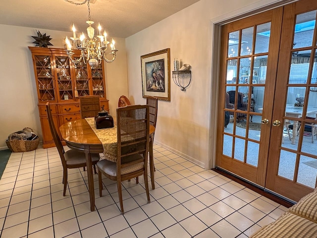 tiled dining room featuring an inviting chandelier and french doors