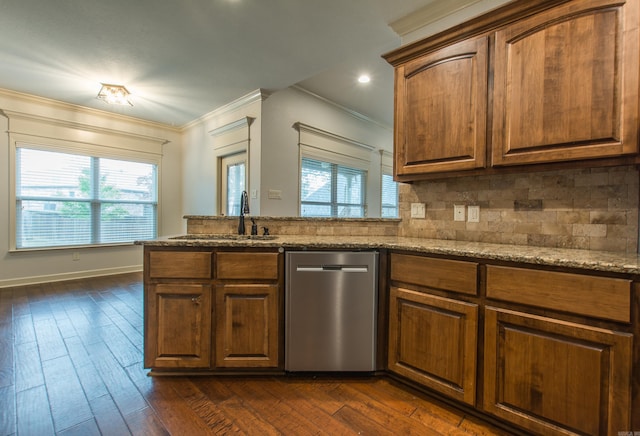 kitchen with dark hardwood / wood-style flooring, stainless steel dishwasher, ornamental molding, and sink