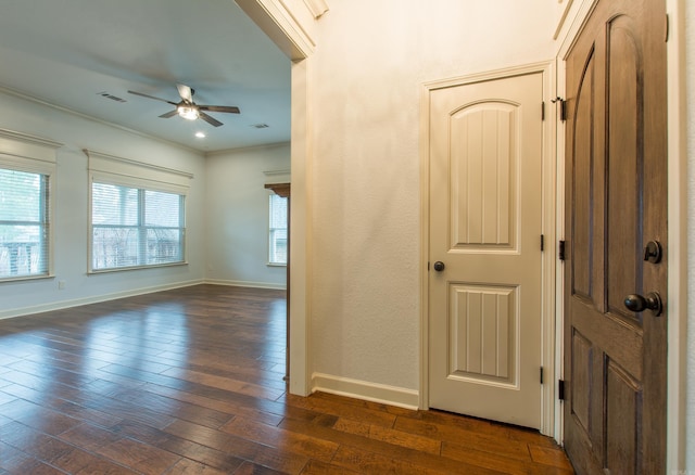 interior space featuring ceiling fan, crown molding, and dark wood-type flooring