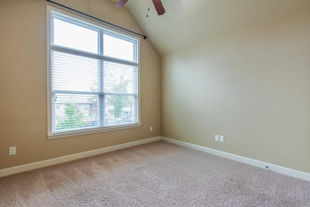 carpeted empty room with ceiling fan and lofted ceiling