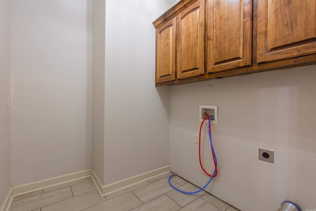 washroom featuring cabinets, washer hookup, and electric dryer hookup