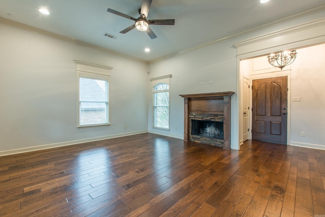 unfurnished living room featuring dark hardwood / wood-style floors, crown molding, and ceiling fan with notable chandelier