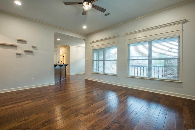 spare room featuring ceiling fan, dark wood-type flooring, and ornamental molding