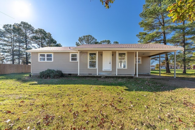 ranch-style house featuring a carport and a front lawn