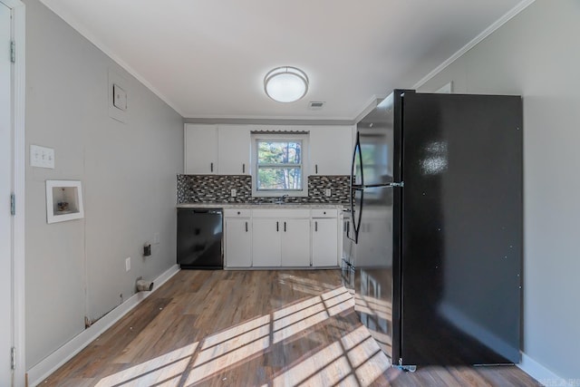 kitchen with white cabinets, light wood-type flooring, black appliances, and crown molding