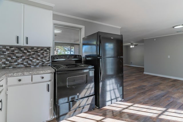 kitchen featuring white cabinets, dark hardwood / wood-style floors, black appliances, and crown molding