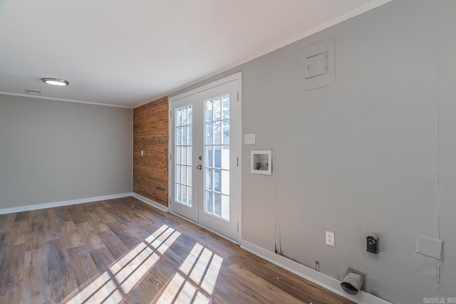 doorway to outside with ornamental molding, french doors, dark wood-type flooring, and wooden walls