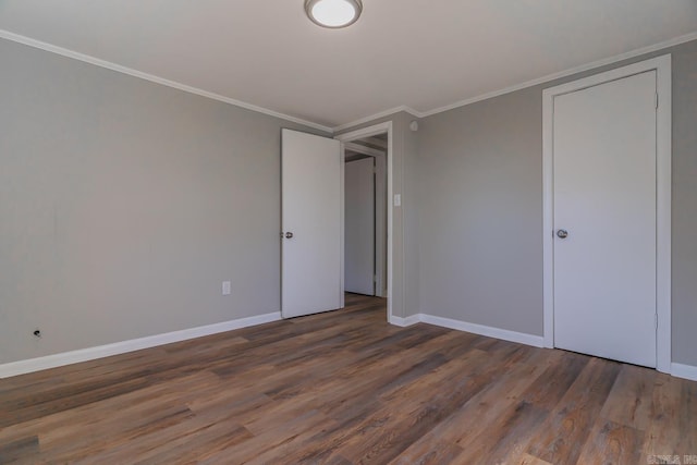 unfurnished bedroom with dark wood-type flooring and ornamental molding