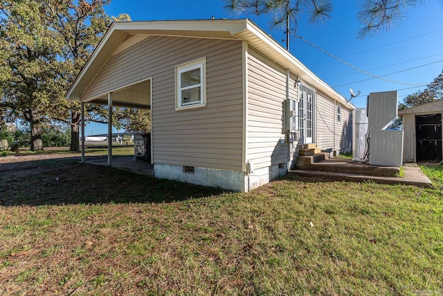 view of side of home with a lawn